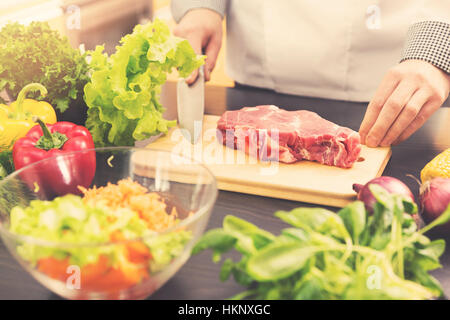 cook is ready for raw meat preparation Stock Photo