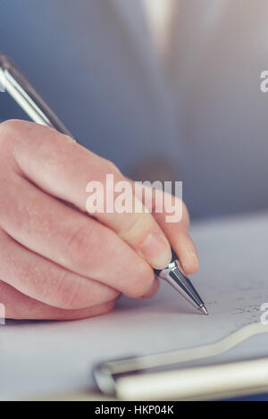 Close up of a businesswoman hand signing a contract on a desk at office ...