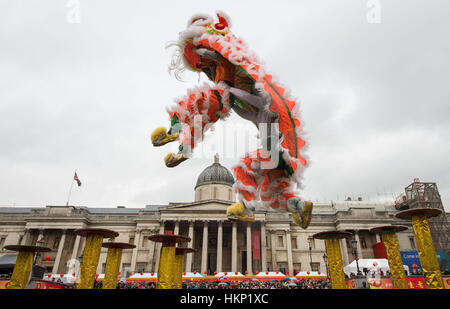 Dancers perform a Chinese flying lion dance in Trafalgar Square, London, as part of the Chinese New Year's celebrations to mark the beginning of the year of the Rooster. Stock Photo