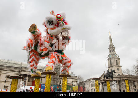 Dancers perform a Chinese flying lion dance in Trafalgar Square, London, as part of the Chinese New Year's celebrations to mark the beginning of the year of the Rooster. Stock Photo