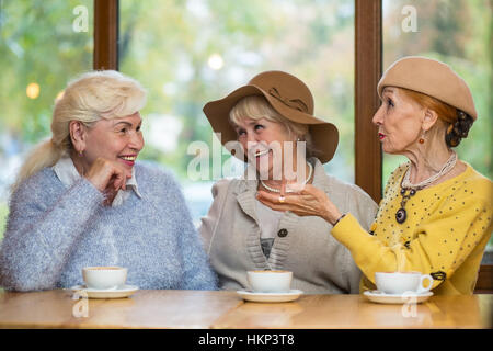 Smiling senior women at table. Stock Photo