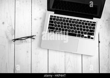 Wooden desk with various gadgets and accessories Stock Photo