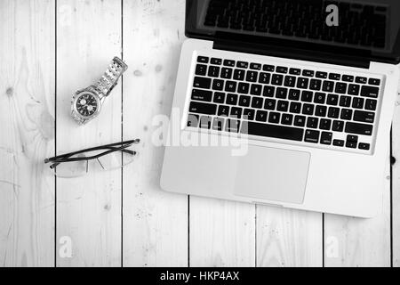 Wooden desk with various gadgets and accessories Stock Photo