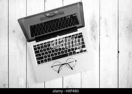 Wooden desk with various gadgets and accessories Stock Photo