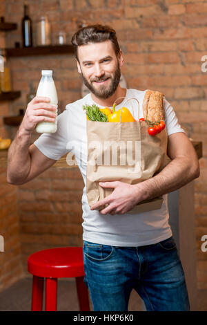 Man with milk and bag full of food Stock Photo