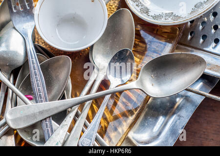Old second-hand crockery, cutlery to sell on the street Stock Photo