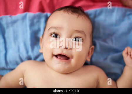 baby portrait laying on bed view from top Stock Photo