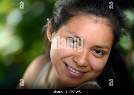 portrait of young woman in green background Stock Photo