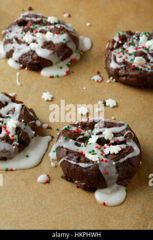 Decorated chocolate Christmas cookies on parchment paper Stock Photo