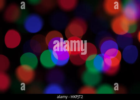 Abstract background with large coloured bokeh lights on black. Stock Photo