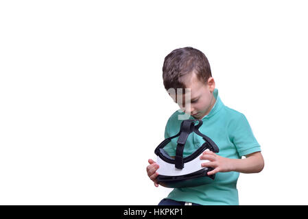 Amazed teen boy wearing virtual reality goggles watching movies or playing video games, isolated on white. Surprised teenager looking in VR glasses. Stock Photo