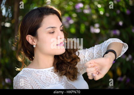 Girl checking the time on her watch Stock Photo