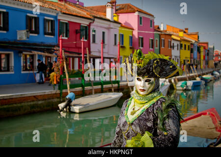 People in mask disguise in carnival. Burano island. Venice, Italy. Stock Photo