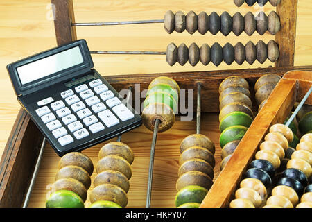 Old wooden abacus and the calculator Stock Photo