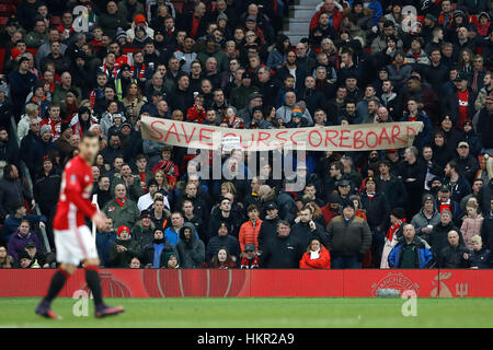 Manchester United supporters protest by unveilling a banner which reads 'save our scoreboard' during the Emirates FA Cup, Fourth Round match at Old Trafford, Manchester. Stock Photo