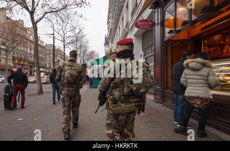 French army soldiers patrolling main street in Paris, France Stock Photo