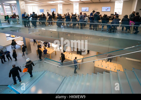 Customers shopping and browsing in the Soho Apple Store in New York City Stock Photo