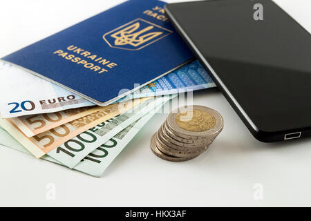Tourism, travel and objects concept - Euro money, smartphone and Ukraine passport on table Stock Photo