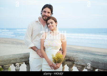 married happy couple on ocean background Stock Photo