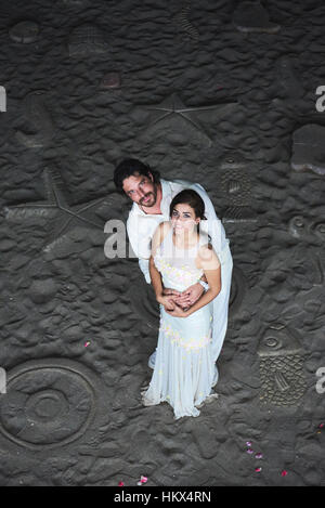 happy just married couple stand on beach sand Stock Photo