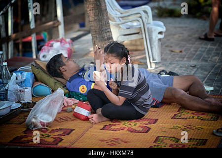 Child Makeup. Growing up. Amusing image of a young girl applying lipstick. Asian girl child Stock Photo