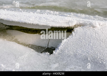 Broken ice on the river during a cold winter under the soft evening sun Stock Photo