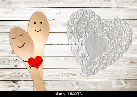 Happy couple hug concept, smiley painted on spoons, valentines day background Stock Photo