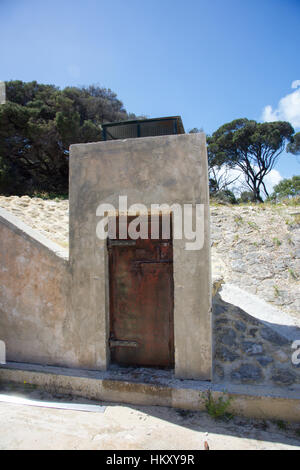 Wooden doorway with concrete exterior at the WWII military installation at Bickley Point at Oliver Hill at Rottnest Island in Western Australia. Stock Photo