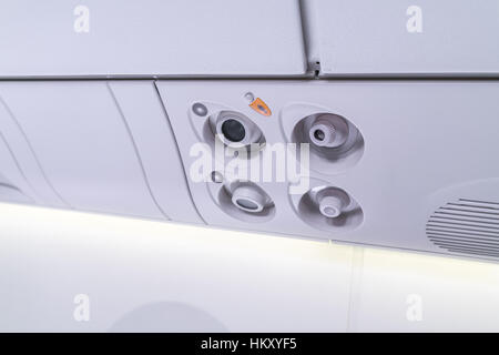 lights, air condition signs panel above the seat on plane Stock Photo