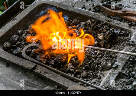 Glowing Embers in a hot wood fire. Ash covered wood glows red in this ...