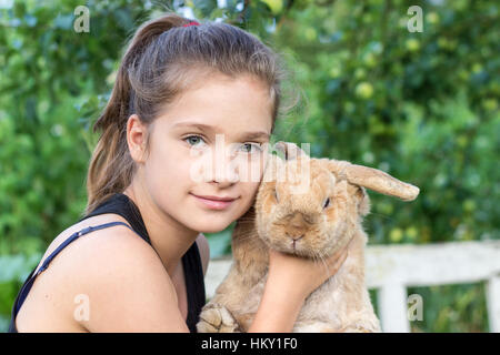 A girl holds a rabbit Stock Photo