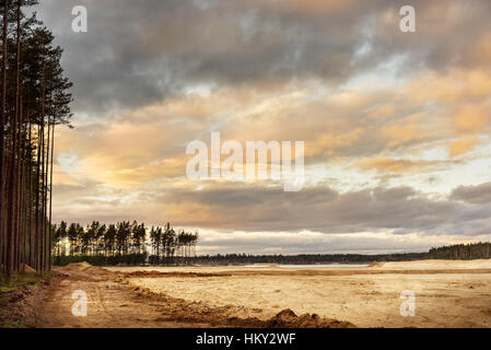 Sand quarry with blue lake under the magnificient sky. Stock Photo