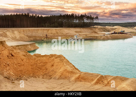 Sand quarry with blue lake under the magnificient sky. Stock Photo