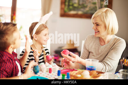 Family together decorating Easter eggs Stock Photo