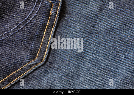 Close up picture of blue jeans fabric with stitches, selective focus, background or texture. Stock Photo