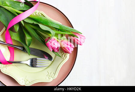 Festive table setting with fresh tulips, top view Stock Photo