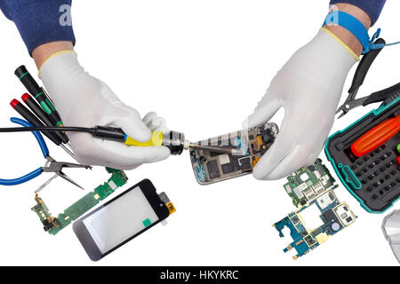 Repair of the  modern smart phones in the professional service center. Repair man uses the ESD antistatic equipment. No brands or logos - only standar Stock Photo