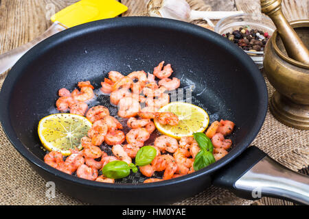 Small shrimp with lemon in a frying pan Stock Photo