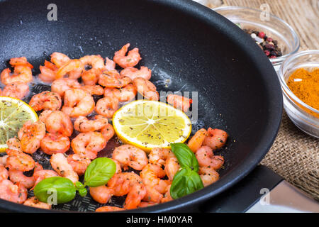 Small shrimp with lemon in a frying pan Stock Photo