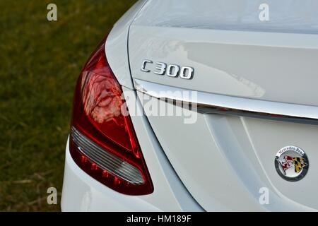 The rear end of a white Mercedes Benz C-300 luxury sedan Stock Photo