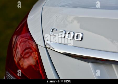 The rear end of a white Mercedes Benz C-300 luxury sedan Stock Photo