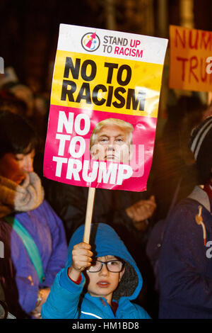 Trump protest UK - A young child carrying an Anti Trump placard in College Green is pictured taking part in a protest rally against President Trump's Muslim Ban. Groups from all over the UK are today taking part in peaceful protests against Donald Trump's presidential executive order which has imposed a ban on people from seven Muslim-majority countries from entering the US. Bristol, UK. 30th January, 2017. Credit: lynchpics/Alamy Live News Stock Photo