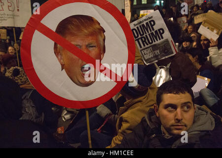 London, UK. 30th Jan, 2017. Demonstrators hold placards during a protest outside Downing Street against U.S. President Donald Trump's ban on travel from seven Muslim countries. President Donald Trump signed an executive order recently banning immigration to the USA from seven Muslim countries. Credit: Thabo Jaiyesimi/Alamy Live News Credit: Thabo Jaiyesimi/Alamy Live News Stock Photo