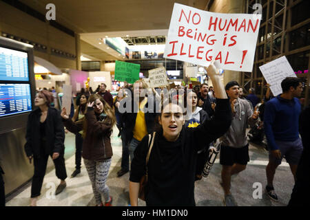 Los Angeles, USA. 29th Jan, 2017. Hundreds march inside the Tom Bradley International Terminal at Los Angeles International Airport (LAX) following Donald Trump's travel ban from Muslim majority countries in Los Angeles, California. Protesters shut down the lower and arrivals area. Credit: Patrick Fallon/ZUMA Wire/Alamy Live News Stock Photo