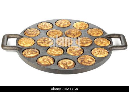 homemade Dutch poffertjes in a traditional cast iron pan isolated on white background Stock Photo