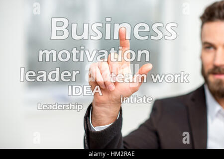 Man touching virtual word cloud on the business topic Stock Photo