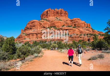 Hikers on the Bell Rock Path walk toward Bell Rock in the Village of Oak Creek near Sedona Stock Photo