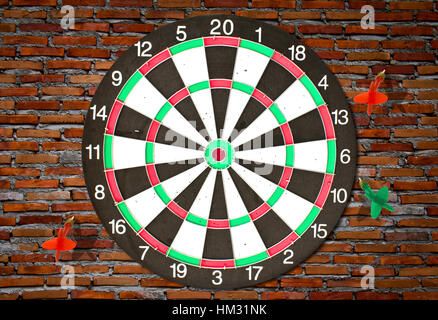 Dartboard on brick wall (Darts Hit Target) Stock Photo