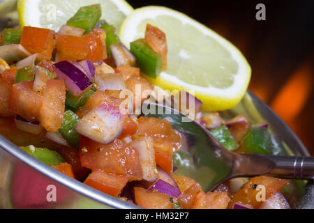 A vegan/vegetarian salad Kachumber with lemon garnish Stock Photo