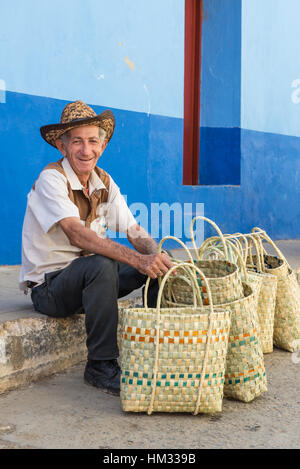 Smiling basket seller on the street in old Trinidad, Cuba Stock Photo